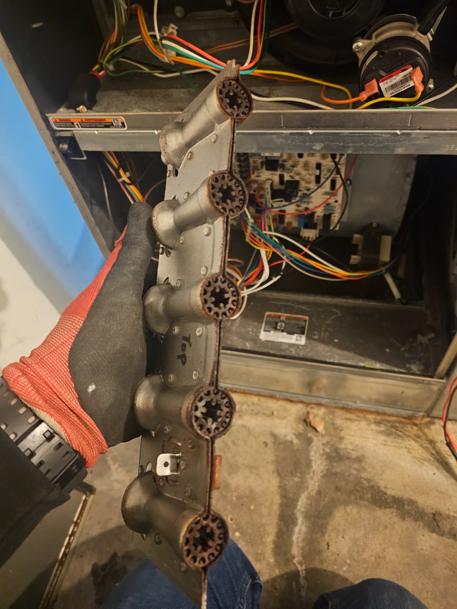 Furnace burner assembly removed during an EMH Mechanical service call